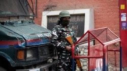 An Indian paramilitary soldier stands guard at the entrance of Press Enclave, which houses several newspaper offices, in Srinagar, Indian-controlled Kashmir, Sept. 8, 2021.