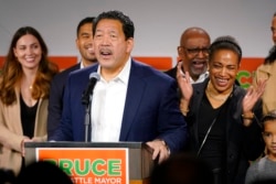 Bruce Harrell, who ran against Lorena Gonzalez in the race for mayor of Seattle, speaks to supporters as his wife, Joanne Harrell, right, applauds, in Seattle, Nov. 2, 2021.