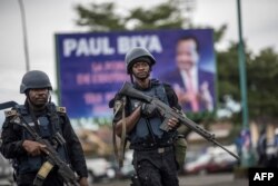 FILE - Members of the Cameroonian Gendarmerie patrol in the Omar Bongo Square of Cameroon's majority anglophone South West province capital Buea during a rally in support of Cameroonian President Paul Biya, Oct. 3, 2018.
