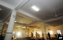 FILE- In this photo released by the Saudi Press Agency SPA, Saudi security forces check the damaged mosque inside a police compound after a suicide bombing attack in the city of Abha, provincial capital of Asir, Saudi Arabia, Aug. 6, 2015. An ISIS affiliate claimed responsibility for the attack.