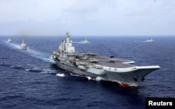 China's aircraft carrier Liaoning takes part in a military drill of Chinese People's Liberation Army (PLA) Navy in the western Pacific Ocean, April 18, 2018.