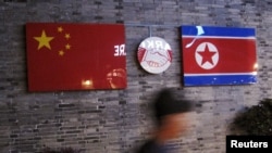 FILE - Flags of China and North Korea are seen outside a closed Korean Restaurant in Ningbo, Zhejiang province, China, April 12, 2016.