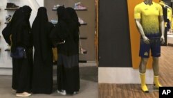 FILE - Saudi women shop at a mall in Riyadh, Saudi Arabia, Dec. 11, 2015. The kingdom has announced a projected budget deficit in 2016 as lower oil prices cut into the government's main source of revenue.