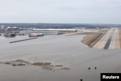 FILE - Offutt Air Force Base and the surrounding areas affected by floodwaters are seen in this aerial photo taken in Nebraska, March 16, 2019.