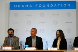 Former U.S. President Barack Obama sits next to Nima Tisdall from Denmark, right, and Rachid Ennassiri from Morocco during a roundtable meeting at the COP26 U.N. Climate Summit in Glasgow, Scotland, Nov. 8, 2021.