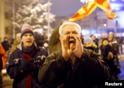 Supporters of the movement boycotting the deal with neighboring Greece to change the country's name to the Republic of North Macedonia protest in front of the parliament building during debates on the name change, in Skopje, Macedonia, Jan. 11, 2019.