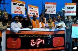 FILE - Demonstrators condemn the suicide bombing at an election rally, in Lahore, Pakistan, July 11, 2018.