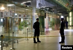 Police stand guard outside a partially closed KLIA2 airport terminal in Sepang, Malaysia, Feb. 26, 2017.