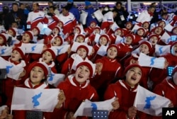 Members of the North Korean delegation hold flags of the combined Koreas before the opening ceremony of the 2018 Winter Olympics in Pyeongchang, South Korea, Feb. 9, 2018.
