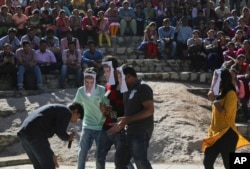 FILE - Indian students wearing Facebook founder, Mark Zuckerberg masks perform a street play during a protest against Facebook’s Free Basics in Hyderabad, India, Dec. 29, 2015.