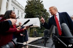 President Donald Trump takes a question as he speaks with reporters before departing for France, on the South Lawn of the White House, Nov. 9, 2018, in Washington.