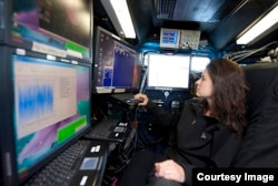 Dr. Karen Kosiba monitors the status of the radar in preparation for the day's scientific mission. (Photo by Jim Reed)