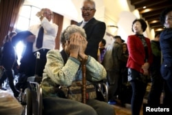 A woman who was selected as a participant for a reunion with family in North Korea reacts at the hotel used as a waiting place in Sokcho, South Korea, Oct. 19, 2015. The reunion of 90 South Koreans and 96 North Koreans will take place Tuesday in the North.