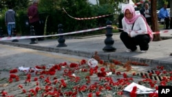 Flowers left behind by mourners are seen at the site of the Oct. 10 explosions in Ankara, Turkey, Oct. 13, 2015.