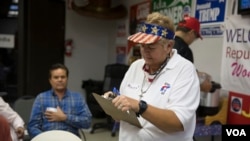 At the GOP headquarters in El Paso, Texas, a volunteer signs people in moments before U.S. Sen. Ted Cruz, R-Texas, narrowly defeated Democratic challenger Beto O'Rourke Tuesday, Nov. 6, 2018.