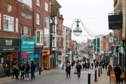 People walk at High Street, amid the coronavirus disease (COVID-19) outbreak, in Windsor, Britain, Jan. 10, 2021.