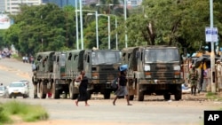 Zimbabwe soldiers are placed where police are clashing with protestors over fuel hikes in Harare, Jan. 14, 2019.