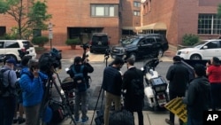 FILE - Reporters are seen during a stake-out in Washington, D.C., May 16, 2019. 