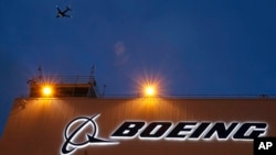 FILE - A sign on Boeing's 737 delivery center, Oct. 19, 2015, at Boeing Field in Seattle. A Southwest Airlines jet leaving Denver was forced to land after the engine cover fell off and struck the wing flap during takeoff. The Boeing 737 landed safely April 7, 2024.
