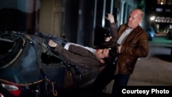 Joseph Gordon-Levitt and Bruce WIllis as &quot;Joe&quot; in TriStar Pictures, Film District, and End Game Entertainment&#39;s action thriller LOOPER.