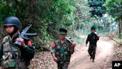 Kachin Independence Army fighters walk in a jungle path from Mu Du front line to Hpalap outpost in an area controlled by the Kachin rebels in northern Kachin state, Myanmar, March 17, 2018. 