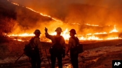Fire crews battle the Kenneth Fire in the West Hills section of Los Angeles, Jan. 9, 2025. (