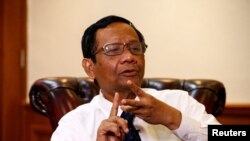 FILE - Indonesian Chief Security Minister Mohammad Mahfud MD is pictured in his office in Jakarta, Dec. 26, 2019. He said Jan. 24, 2020, that detained U.S. journalist Philip Jacobson should be deported.  