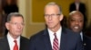 Newly-elected Senate Majority Leader Sen. John Thune, R-S.D., center, flanked by Sen. John Barrasso, R-Wyo., left, and Sen. Tim Scott, R-S.C., right, speaks at a news conference on Capitol Hill, Nov. 13, 2024, in Washington.