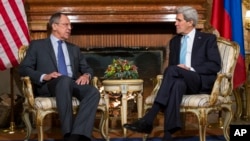 U.S. Secretary of State John Kerry, right, and Russian Foreign Minister Sergei Lavrov talk during their meeting at Villa Taverna in Rome, Italy, Dec. 14, 2014.