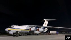 In this official Ukrainian photo, a plane with Ukrainian experts prepares to leave for Tehran at the Boryspil airport outside Kyiv, Ukraine, Jan. 8, 2020. Questions have arisen about who will investigate the crash of a Ukrainian plane in Iran. 