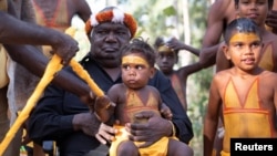 Yunupingu, an influential Australian Indigenous leader, is seen holding a child in this 2019 handout photo in Australia. Peter Eve/Yothu Yindi Foundation/Handout via REUTERS