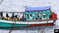 FILE - Fishing boat carrying Vietnamese asylum seekers nears shore of Australia's Christmas Island, April 14, 2013.