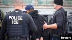 U.S. Immigration and Customs Enforcement officers detain a suspect as they conduct a targeted enforcement operation in Los Angeles, Feb. 7, 2017.