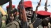 FILE - Government soldiers follow orders to raise their guns during a military parade in Juba, South Sudan, April 14, 2016. 