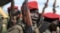 FILE - Government soldiers follow orders to raise their guns during a military parade in Juba, South Sudan, April 14, 2016. 