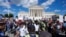 U.S. Supreme Court Police officers and U.S. Capitol Police officers place barriers between anti-abortion and abortion-rights demonstrators outside the Supreme Court, June 24, 2024, in Washington. 