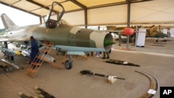 FILE - Nigerian Airforce officers display ammunition next to a fighter jet during an event to celebrate the 53rd Anniversary of the Nigeria Airforce, April. 22, 2017, in Makurdi, Nigeria.