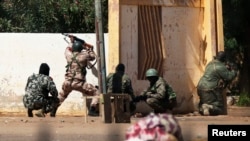 Malian soldiers fire at Islamists' positions at the mayor's office, in Gao, Mali, February 21, 2013.