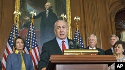Israeli Prime Minister Benjamin Netanyahu, accompanied by House of Representatives members, gestures during a news conference on Capitol Hill in Washington, March 6, 2012.