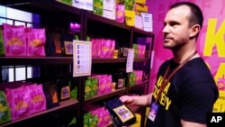 Kaffa Roastery's founder Svante Hampf shows package of "AI-conic" coffee blend generated by artificial intelligence in Helsinki, Finland, Friday April 19, 2024. (AP Photo/Jari Tanner)