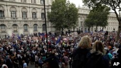 Anti-Brexit supporters gather outside the Prime Minister's residence 10 Downing Street in London, Wednesday, Aug. 28, 2019.