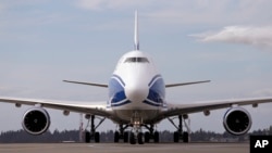 A new Boeing 787-8 freighter jet taxis after landing Oct. 7, 2016, at Seattle-Tacoma International Airport. The sale or lease of hundreds of Boeing and Airbus jets is in jeopardy after the U.S. House of Representatives passed a bill Thursday, Nov. 17, 2016, that would block the sale of commercial aircraft to Iran. 