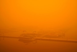 Boats are partially obscured by smoke from a wildfire at a marina on Detroit Lake burned by the Beachie Creek Fire, Sept. 12, 2020, in Detroit, Ore.