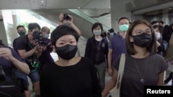 Bao Choy Yuk-Ling, a freelance producer with RTHK, leaves court after she was found her guilty of making false statements to obtain data for a documentary on the police's handling of a mob attack on pro-democracy protesters, in Hong Kong, April 22, 2021.