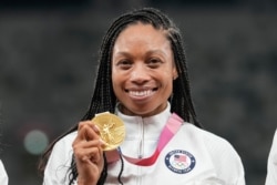 Allyson Felix, of United States, poses with her gold medal for the women's 4 x 400-meter relay at the 2020 Summer Olympics, Aug. 7, 2021, in Tokyo.