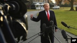 President Donald Trump speaks to reporters on the South Lawn of the White House in Washington, Dec. 4, 2017.