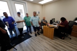 Laid-off workers in LaPlace, Louisiana, line up for job searches after the steel mill where they worked unexpectedly shut down, Oct. 1, 2019.