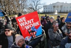 FILE - Union members and other federal employees stop in front of the White House in Washington during a rally to call for an end to the partial government shutdown, Jan. 10, 2019.