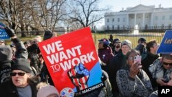 FILE - Union members and other federal employees stop in front of the White House in Washington during a rally to call for an end to the partial government shutdown, Jan. 10, 2019.