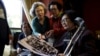 South Korean participants for a reunion check old pictures at a hotel used as a waiting place in Sokcho, South Korea, Oct. 19, 2015. The reunion of 90 South Koreans and 96 North Koreans, the 20th of its kind, will be held at a resort in the North.